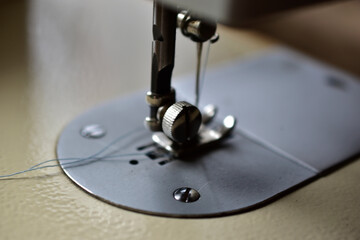 Sewing machine and work surface with needle and thread