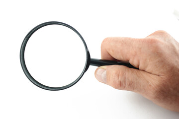 Hand holds magnifying glass isolated on white background.