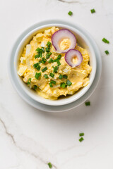 Egg spread with onion and chives on marble background