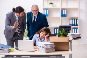 Two male and one female employees working in the office