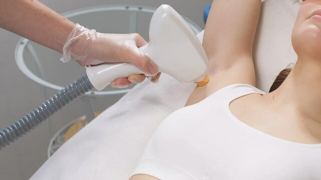 Skin care concept. Young woman get laser epilation procedure.