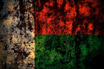 Madagascar flag on grunge metal background texture with scratches and cracks