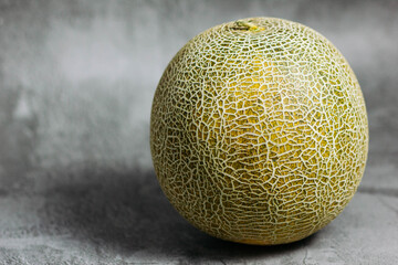 BEAUTIFUL MELON ON A GRAY BACKGROUND