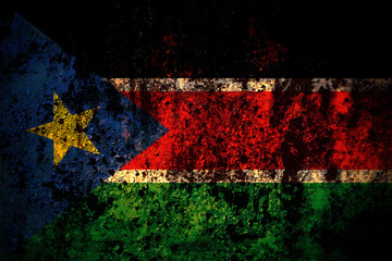 South Sudan flag on grunge metal background texture with scratches and cracks
