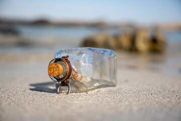 Message in the bottle against the Sun setting down