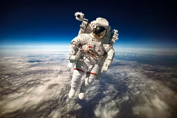 Tuinposter Astronaut in outer space against the backdrop of the planet earth. Elements of this image furnished by NASA. © Andrei Armiagov