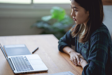 Asian women working at home using a lab. Graphic design. Working with pleasure. Concept work at home.