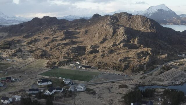 Football pitch in lofoten islands. located in norway, far beyond the arctic circle. Drone video of football tema practice. Located in beautiful area of mountains and see. Living on islands be like