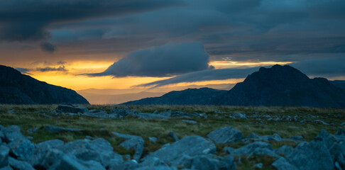 View of Tryfan and Pen Yr Ole Wen before sunset with moody clouds above in Snowdonia National Park