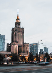 Evening shot of the Palace of Culture and Science and downtown business skyscrapers, city center of Warsaw, Poland.