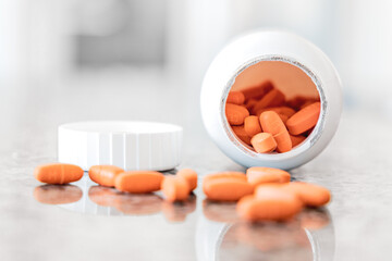 orange medicine pills and bottle - vitamin pills