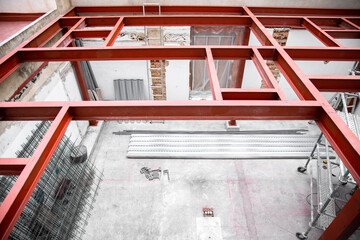 Structural building supports - building under construction - steel girders used for construction - construction site 