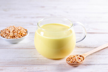 Pea milk. A picture of peeled split peas bean with a glass of milk on the table.