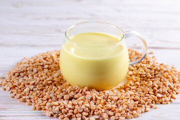 Vegetable pea milk in glass and peas on the table. Nut free, soy free, lactose free, gluten free concept