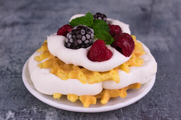 Waffles with berries and tender cream. Close-up.