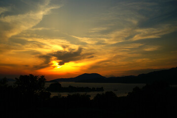 Romantic sunset over lake with nice clouds.