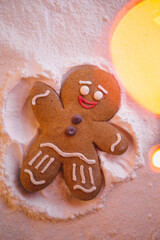 Happy New Year: ginger little man lies on the ground and with the help of his hands and feet makes the shape of an angel leaving a footprint in the snow