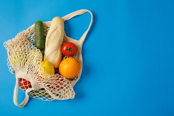 mesh shopping bag flat lay on blue background