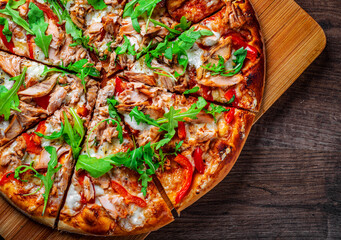 Pizza with Mozzarella cheese, salmon fish, tomato sauce, pepper. Italian pizza on wooden table background