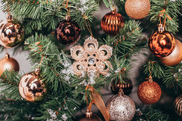 Christmas toys, golden balls and star hanging on green tree. New Year decoration.