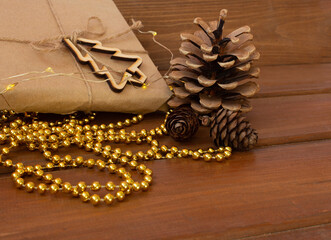 fir-tree cones and tangerine on a wooden table. New Year 2021. Christmas mood