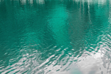 Clear turquoise water with glints of light in the lake