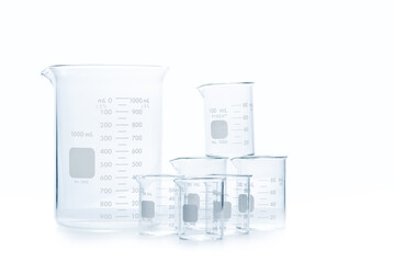Mix size of measuring beakers for science experiment in laboratory isolated