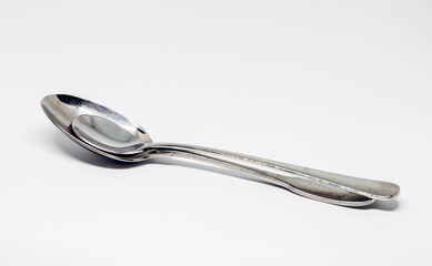 two metal spoons on white background