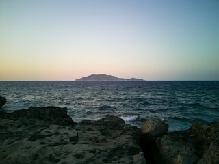 The rocky coast landscape of the island of Favignana in the Egadi islands archipelago at sunset time