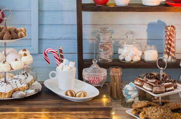 Christmas bar cacao decoration with cookies and sweets on blue wooden background in vintage style