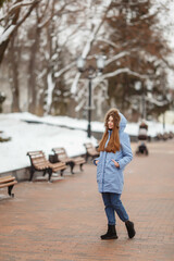 young woman are walking in the winter park. Winter park in the snow. Clothing advertising photo concept