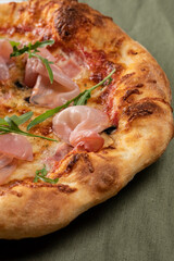 Homemade pizza with champignon mushrooms and ham, close up