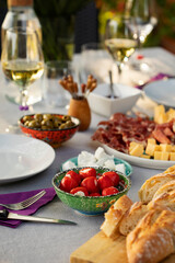 Set up table with white wine and appetizers