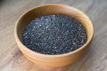 Close-up of a bowl of chia seeds in a wooden bowl