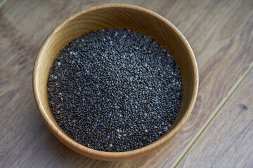 Close-up of a bowl of chia seeds in a wooden bowl