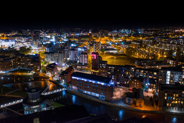 Naklejka premium Night time aerial photo of the the town centre of Leeds in the UK, showing the West Yorkshire British city from above in the evening time