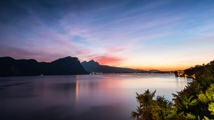 Fototapeta premium A magnificent sunset over Lake Lucerne. City lights. Top of Mount Pilatus. Switzerland.