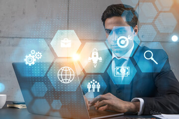 Businessman in office working with laptop, develop fintech approach to business, typing computer assemble data for new opportunities. Double exposure.