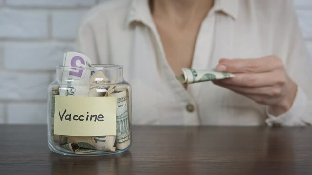 Finance for vaccination. A woman save dollars forn infection vaccination indoor.