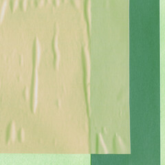 Green torn paper collage close-up. Texture made from various paper and cardboard parts. Damaged old paper background. Vintage blank wallpaper. Material design backdrop.