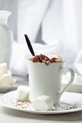 Hot chocolate with marshmallows sprinkled with chocolate crumbs.