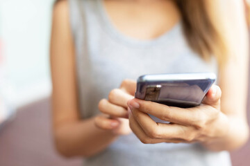 Women are typing messages choose products online,in the park.