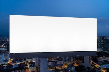 Blank white road billboard with KL cityscape background at night time. Street advertising poster,...