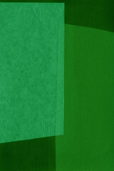 Green torn paper collage close-up. Texture made from various paper and cardboard parts. Damaged old paper background. Vintage blank wallpaper. Material design backdrop.