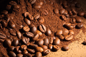 Coffee beans and coffee powder (ground coffee) brown background.