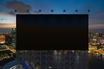 Blank black road billboard with Singapore cityscape background at night time. Street advertising poster, mock up, 3D rendering. Front view. The concept of marketing communication to sell idea. © VideoFlow