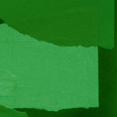 Green torn paper collage close-up. Texture made from various paper and cardboard parts. Damaged old paper background. Vintage blank wallpaper. Material design backdrop.