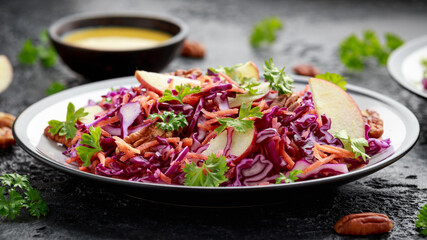 Red Cabbage salad with carrots, apples and pecan nuts. Healthy vegan food