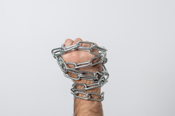 Fototapeta na wymiar Men's hands in chains. Male hands break the metal chain.