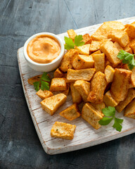 Patatas bravas traditional Spanish potatoes snack tapas on white wooden board